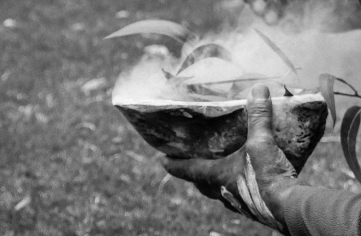 Uncle Dean Kelly performs a smoking ceremony