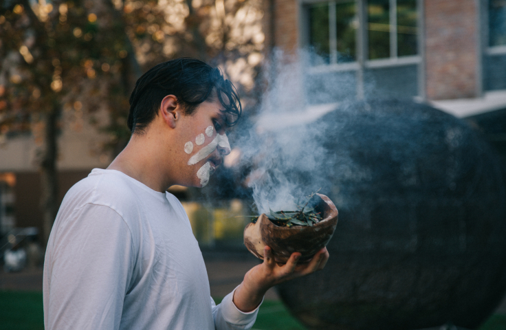 Local Aboriginal community member conducts smoking ceremony